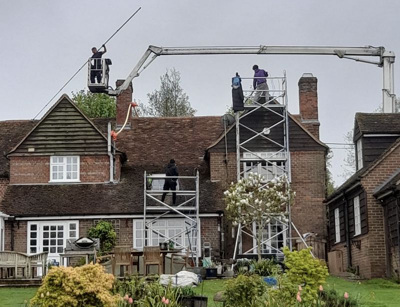 The Roof Moss Cleaners using cherry picker and scaffolding to clean roof safely and professionally in Tewkesbury, Gloucestershire